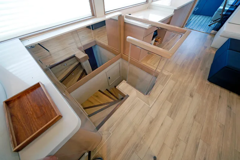 Slide: The Image of Interior of 1995 Hatteras 74 Cockpit Motor Yacht with wooden stairs and modern design. - 16