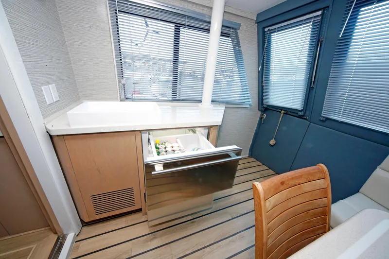 Slide: The Image of Interior of 1995 Hatteras 74 Cockpit Motor Yacht with open drawer fridge. - 20