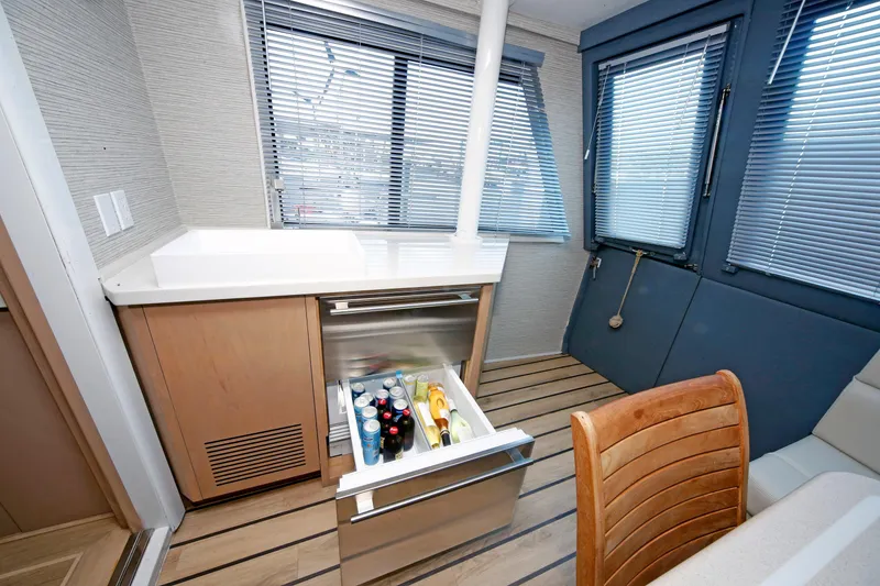 Slide: The Image of Interior of 1995 Hatteras 74 Cockpit Motor Yacht with open fridge drawer. - 21