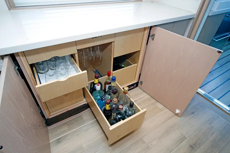 Slide: The Image of Cabinet with glassware and liquor bottles on a 1995 Hatteras 74 Cockpit Motor Yacht. - 22