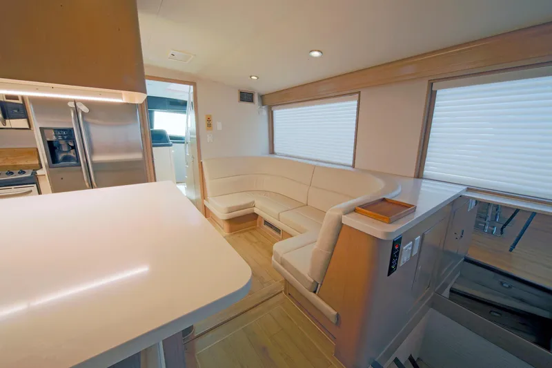 Slide: The Image of Interior of 1995 Hatteras 74 Cockpit Motor Yacht with modern kitchen and seating area. - 25