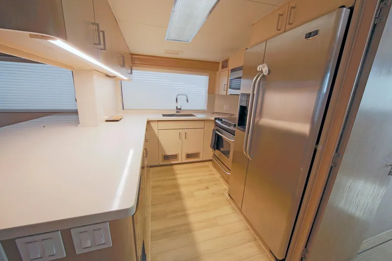 Slide: The Image of Modern kitchen in 1995 Hatteras 74 Cockpit Motor Yacht with stainless steel appliances. - 26