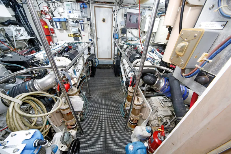 Slide: The Image of Engine room of 1995 Hatteras 74 Cockpit Motor Yacht, showcasing machinery and equipment. - 28