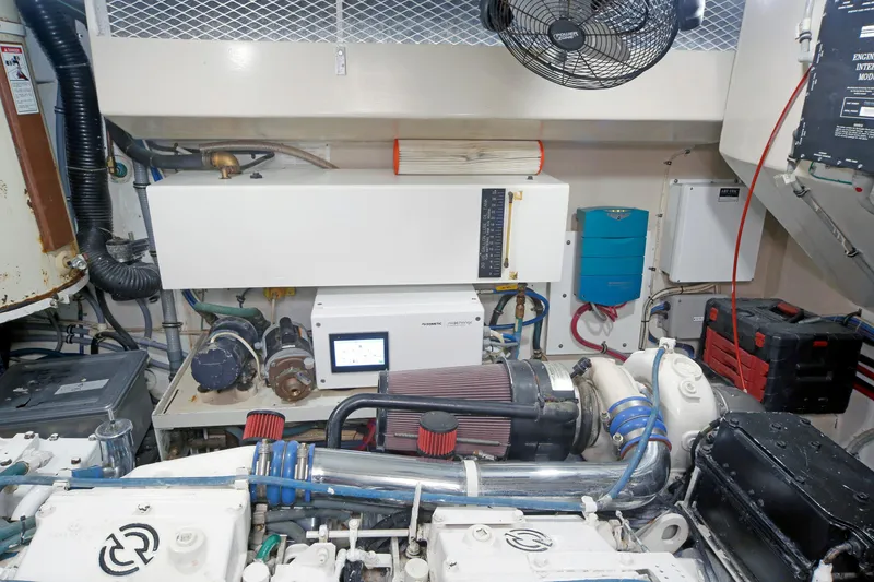 Slide: The Image of Engine room of 1995 Hatteras 74 Cockpit Motor Yacht with mechanical components and ventilation. - 35
