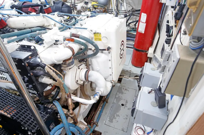 Slide: The Image of Engine room of 1995 Hatteras 74 Cockpit Motor Yacht with visible machinery and components. - 38
