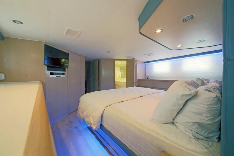 Slide: The Image of Luxurious bedroom interior of 1995 Hatteras 74 Cockpit Motor Yacht with modern amenities. - 43