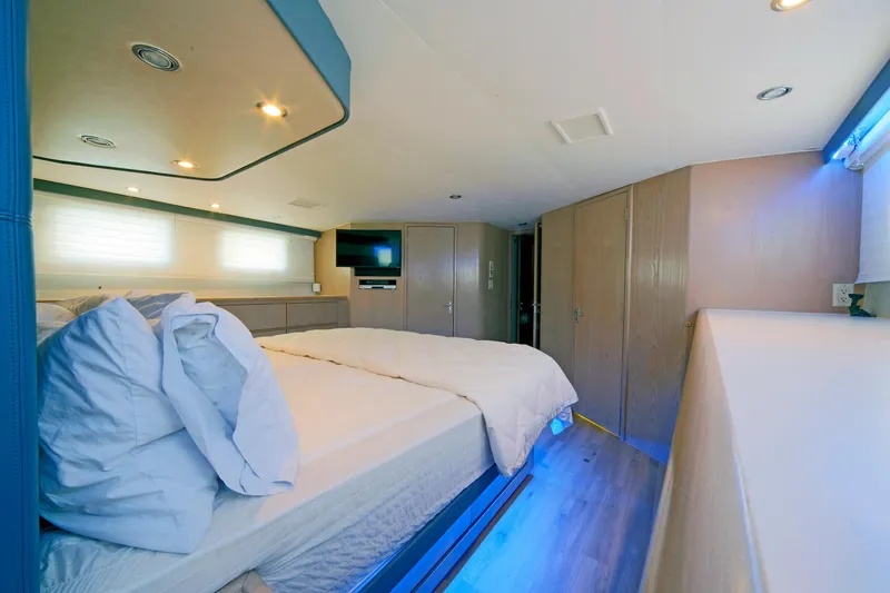 Slide: The Image of Luxurious bedroom interior of 1995 Hatteras 74 Cockpit Motor Yacht with modern amenities. - 44