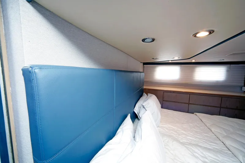 Slide: The Image of Interior cabin of 1995 Hatteras 74 Cockpit Motor Yacht with blue headboard. - 46