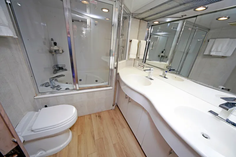 Slide: The Image of Luxurious bathroom in 1995 Hatteras 74 Cockpit Motor Yacht with dual sinks and shower. - 47