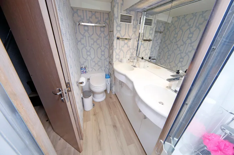 Slide: The Image of Bathroom interior of 1995 Hatteras 74 Cockpit Motor Yacht with dual sinks and modern decor. - 48