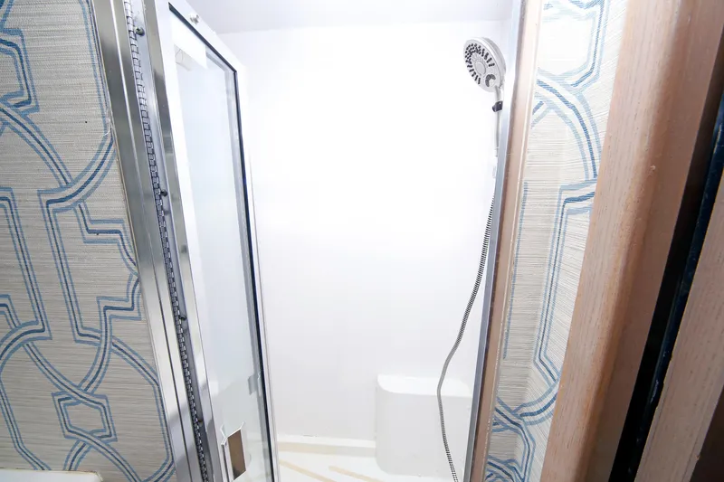 Slide: The Image of Shower area in 1995 Hatteras 74 Cockpit Motor Yacht with patterned walls and modern fixtures. - 49