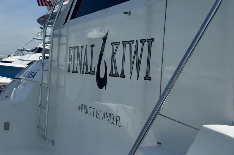 Slide: The Image of 1995 Hatteras 74 Cockpit Motor Yacht, "Final Kiwi," Merritt Island, FL, docked with ladder. - 5