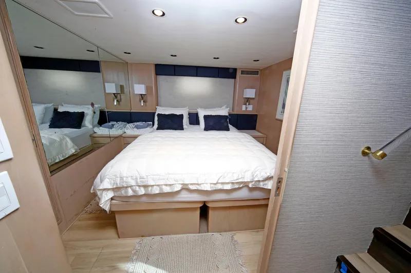 Slide: The Image of Luxurious bedroom interior of 1995 Hatteras 74 Cockpit Motor Yacht with cozy bedding. - 50