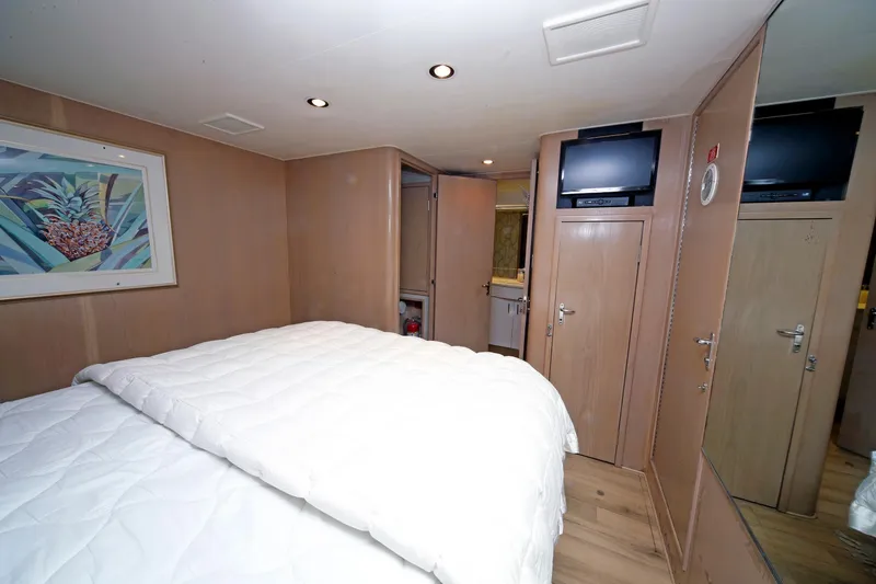 Slide: The Image of Luxurious bedroom interior of 1995 Hatteras 74 Cockpit Motor Yacht with modern amenities. - 52