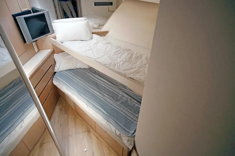 Slide: The Image of Interior cabin of 1995 Hatteras 74 Cockpit Motor Yacht with cozy bedding and TV. - 54