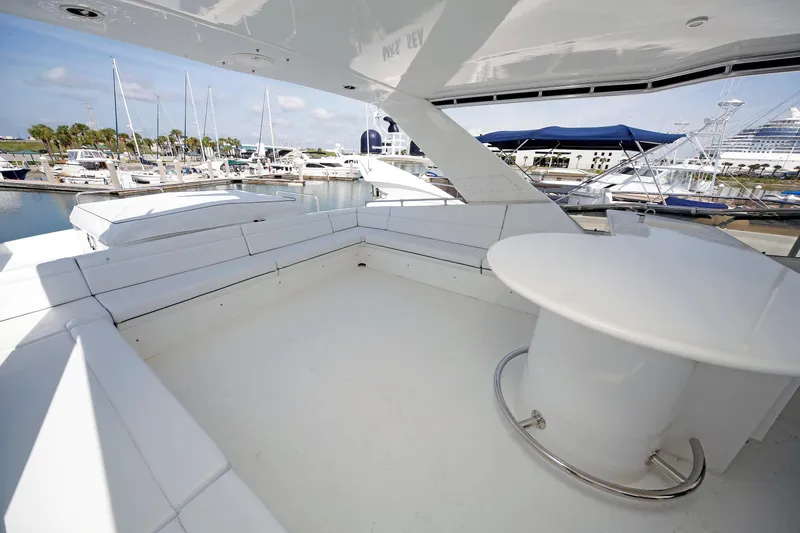 Slide: The Image of Spacious deck of 1995 Hatteras 74 Cockpit Motor Yacht in marina setting. - 65
