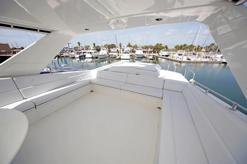 Slide: The Image of Spacious deck of 1995 Hatteras 74 Cockpit Motor Yacht in marina setting. - 66
