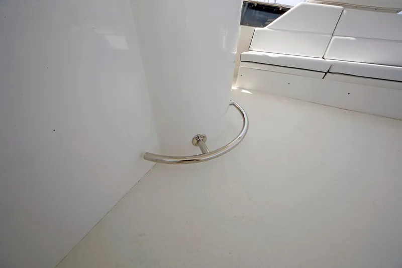 Slide: The Image of Interior of 1995 Hatteras 74 Cockpit Motor Yacht with white seating and metal railing. - 73