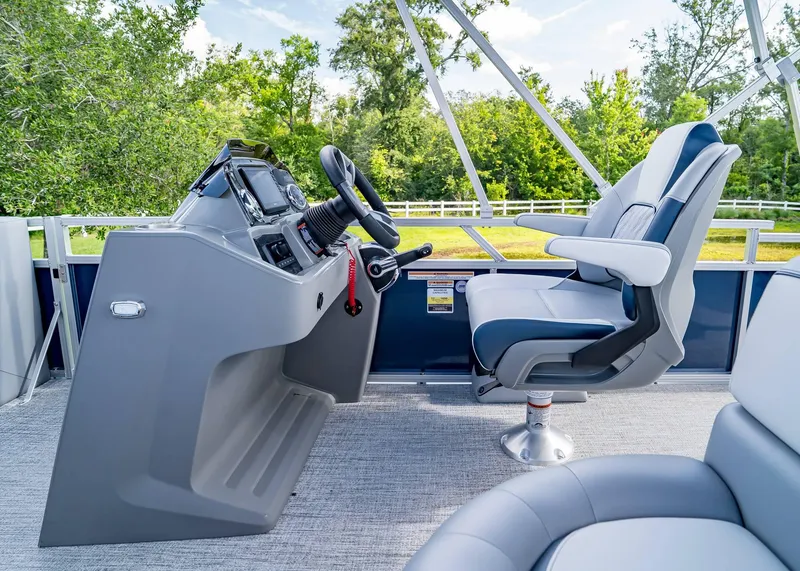 Slide: The Image of 2025 Tahoe SPORTS 85 REAR FISH boat interior with captain's chair and control panel. - 11