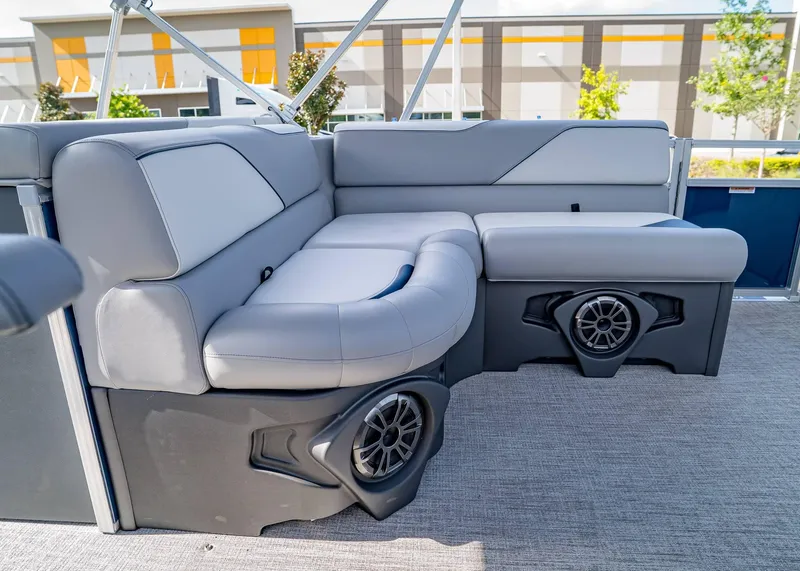 Slide: The Image of 2025 Tahoe SPORTS 85 REAR FISH boat interior with gray seating and built-in speakers. - 15