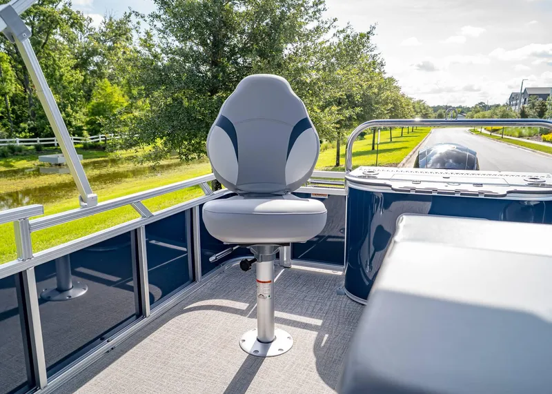Slide: The Image of 2025 Tahoe SPORTS 85 REAR FISH boat with swivel seat, scenic outdoor view. - 18