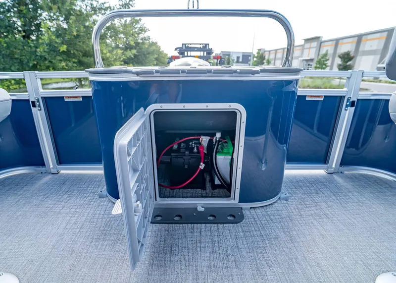 Slide: The Image of 2025 Tahoe SPORTS 85 REAR FISH boat with open storage compartment, revealing battery and wiring. - 27