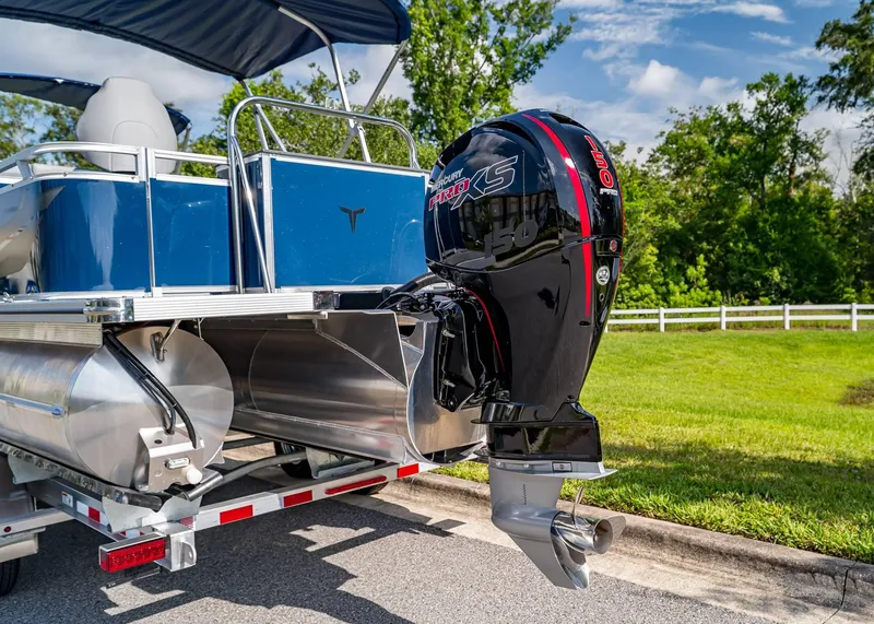 Slide: The Image of 2025 Tahoe SPORTS 85 REAR FISH boat with Mercury Pro XS engine, parked outdoors. - 3