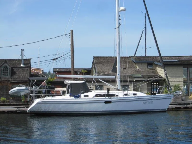The Image of 2024 Catalina 385 sailboat docked by waterfront buildings. - 0