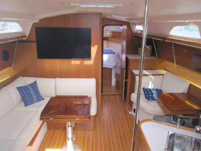 Slide: The Image of Luxurious interior of 2024 Catalina 385 yacht with modern furnishings and wood finish. - 1