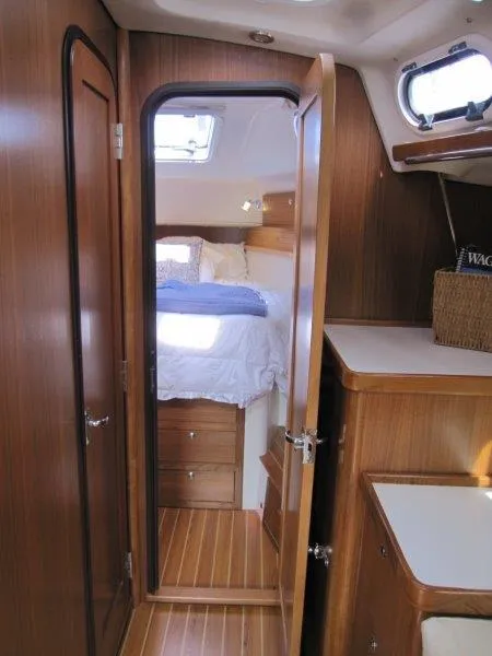 Slide: The Image of Interior of 2024 Catalina 385 sailboat, featuring cozy wooden cabin and comfortable bedding. - 14
