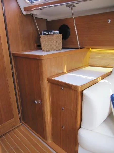 Slide: The Image of 2024 Catalina 385 yacht interior with wooden cabinetry and white seating. - 18