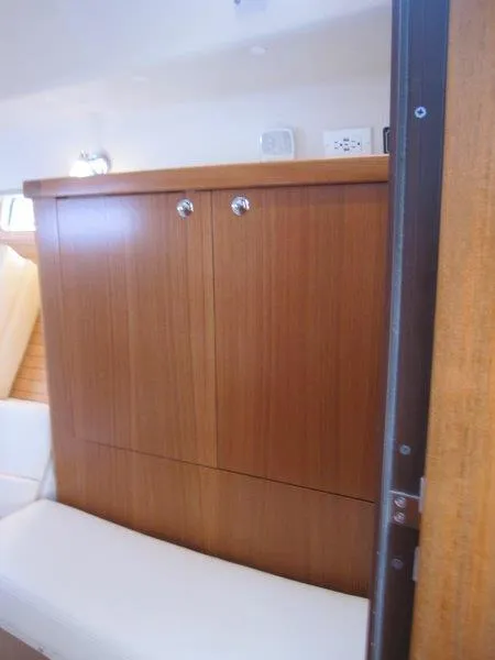 Slide: The Image of 2024 Catalina 385 interior with wooden cabinetry and seating. - 24
