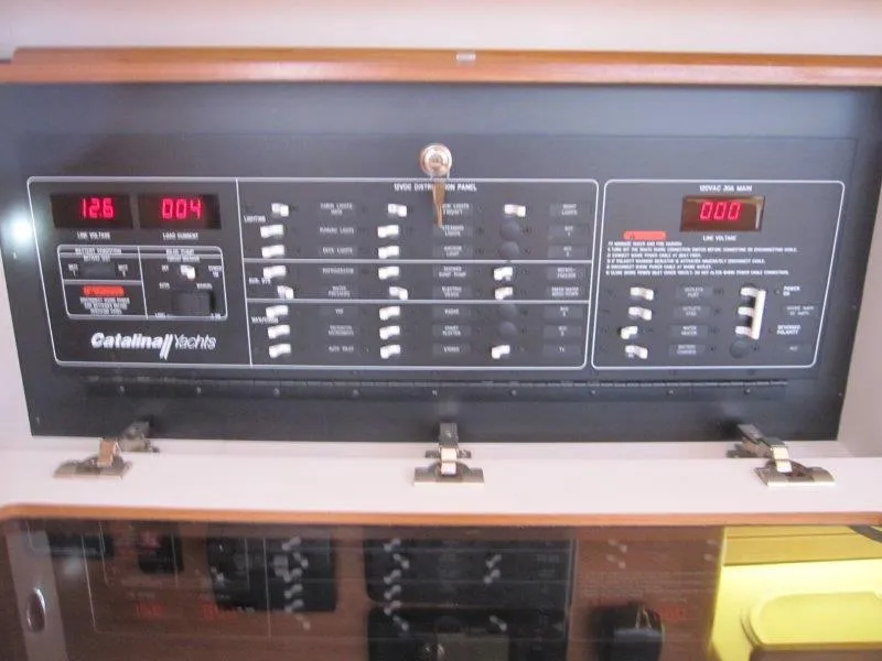 Slide: The Image of Electrical control panel of a 2024 Catalina 385 yacht with various switches and displays. - 28