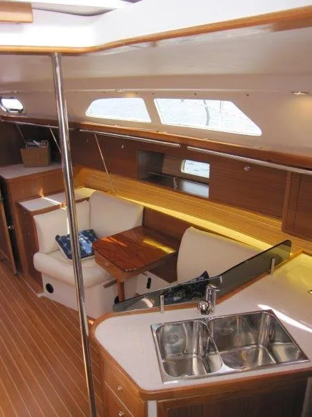 Slide: The Image of Interior of 2024 Catalina 385 sailboat with modern kitchen and cozy seating area. - 3