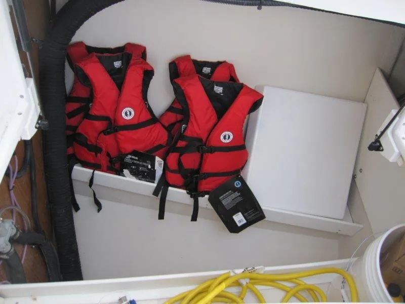 Slide: The Image of Red life jackets stored in a Catalina 385 sailboat, model year 2024. - 30