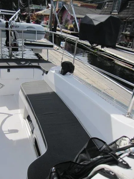 Slide: The Image of 2024 Catalina 385 sailboat deck with seating, docked at marina. - 32