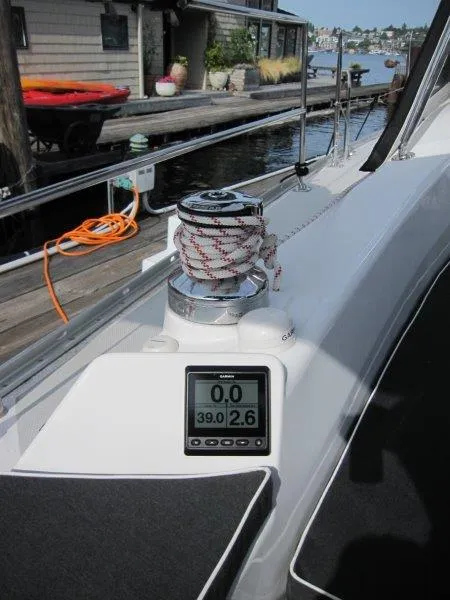 Slide: The Image of 2024 Catalina 385 sailboat deck with winch and digital display, docked by waterfront. - 34