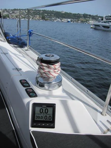Slide: The Image of 2024 Catalina 385 sailboat deck with winch and digital display on a calm lake. - 35
