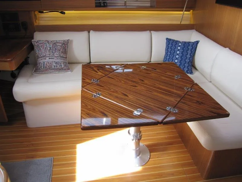 Slide: The Image of Luxurious Catalina 385 yacht interior with elegant wood table and plush seating, 2024 model. - 4