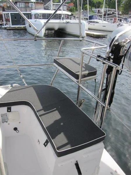Slide: The Image of 2024 Catalina 385 sailboat deck with seating, docked in a marina. - 41