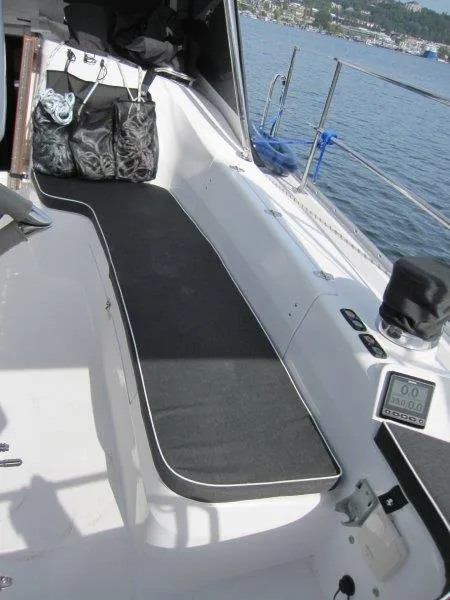 Slide: The Image of 2024 Catalina 385 sailboat cockpit with seating, storage bags, and water view. - 42
