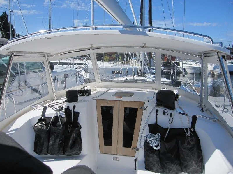 Slide: The Image of 2024 Catalina 385 sailboat cockpit with storage bags and clear skies. - 45