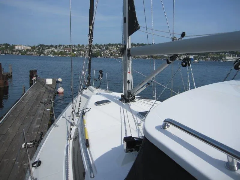 Slide: The Image of 2024 Catalina 385 sailboat docked by a scenic waterfront. - 49