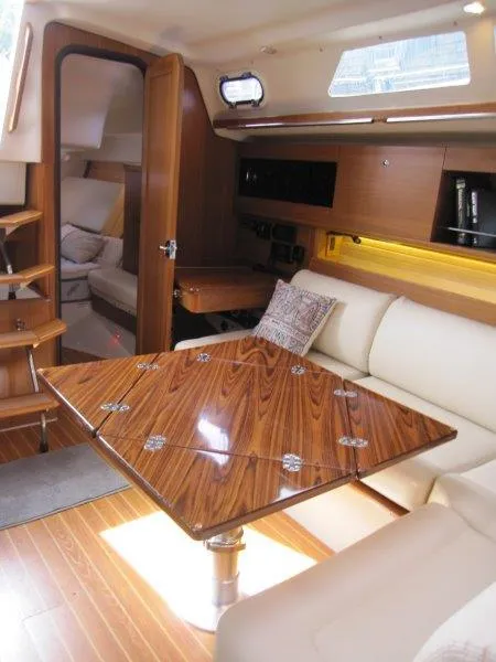 Slide: The Image of Luxurious interior of 2024 Catalina 385 yacht with wooden table and plush seating. - 5
