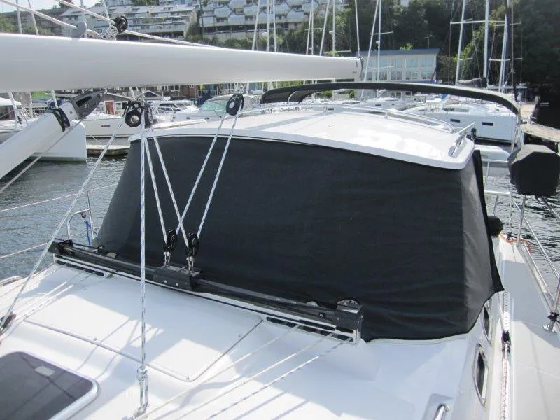 Slide: The Image of 2024 Catalina 385 sailboat with covered cockpit, docked in a marina. - 50