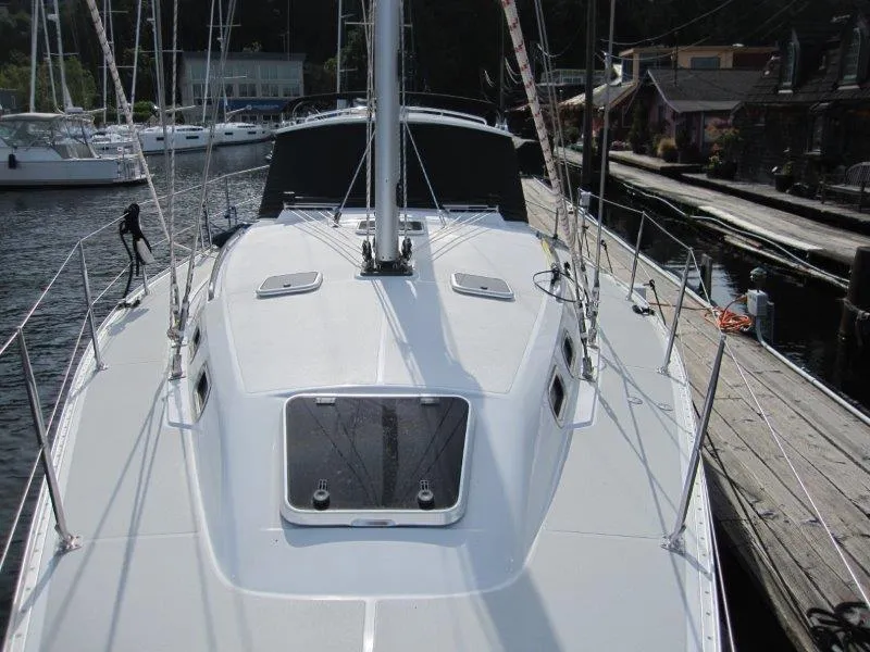 Slide: The Image of 2024 Catalina 385 sailboat docked at marina, showcasing sleek deck design. - 55