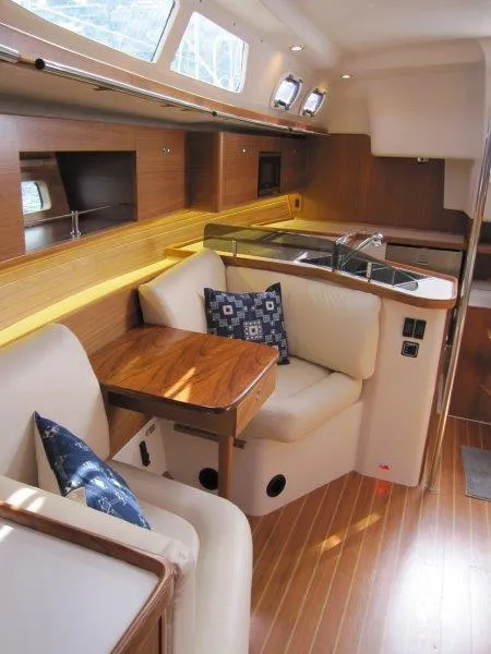 Slide: The Image of 2024 Catalina 385 yacht interior with wooden finish and cozy seating area. - 6