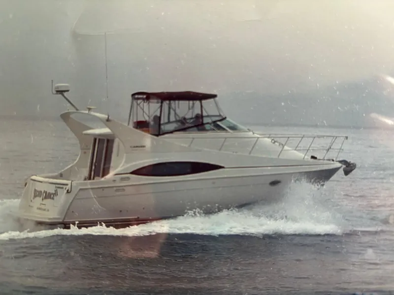 Slide: The Image of 2002 Carver 350 Mariner yacht cruising on open water. - 1