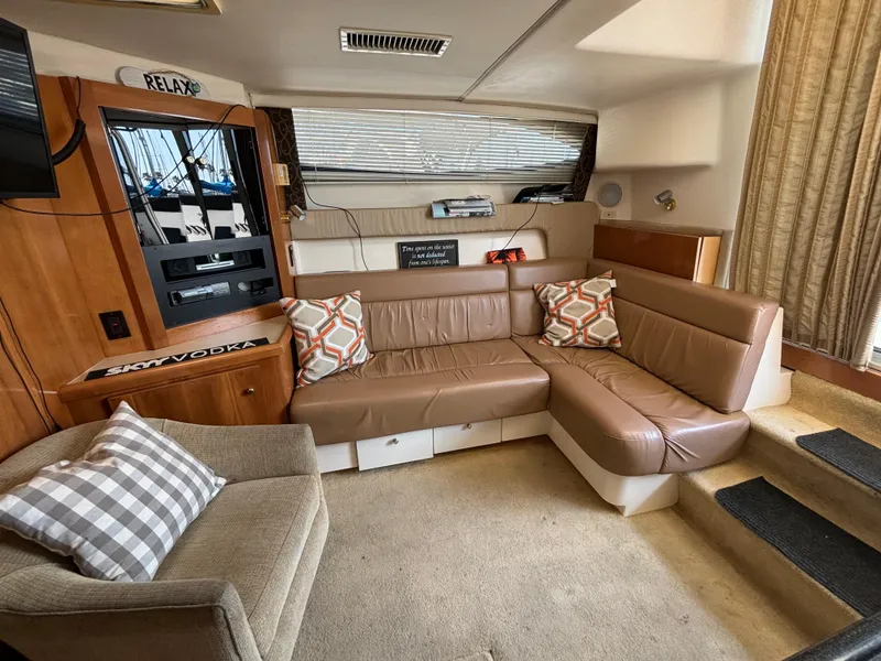 Slide: The Image of Interior of 2002 Carver 350 Mariner with brown leather seating and decorative pillows. - 11