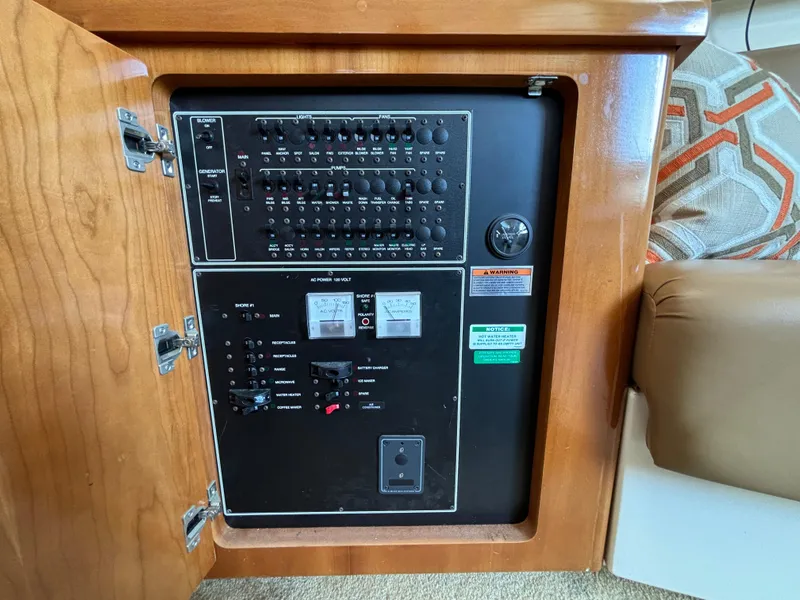 Slide: The Image of Electrical panel inside 2002 Carver 350 Mariner boat, featuring switches and controls. - 13